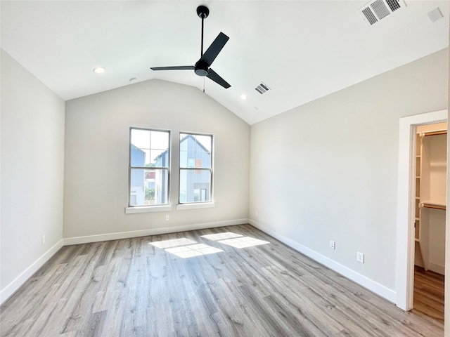 interior space featuring light wood-type flooring, a spacious closet, ceiling fan, and lofted ceiling