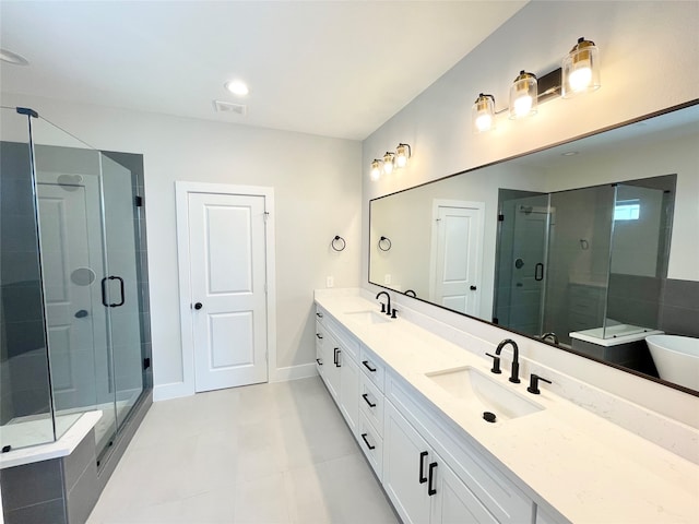 bathroom featuring tile patterned flooring, vanity, and shower with separate bathtub