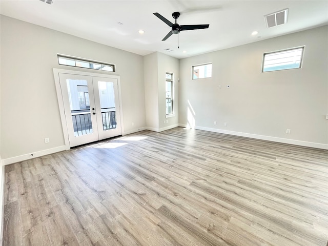 empty room with french doors, light hardwood / wood-style flooring, and ceiling fan