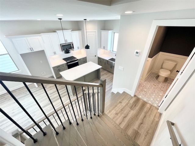 stairs with wood-type flooring and vaulted ceiling