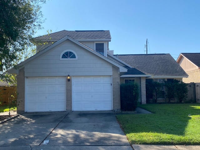 view of front of property featuring a garage and a front lawn