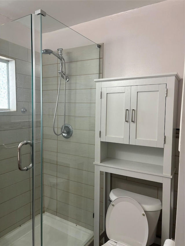 bathroom featuring toilet and walk in shower