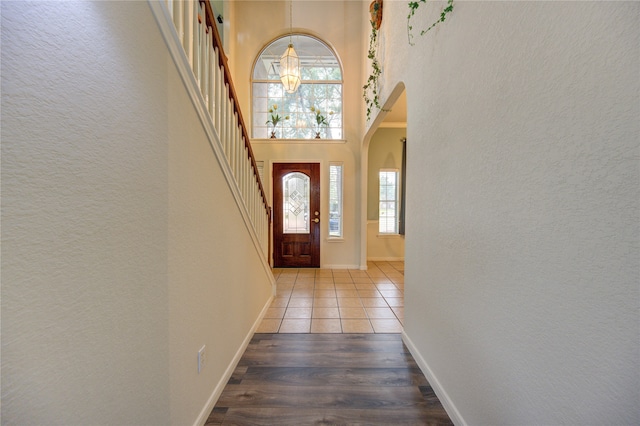 foyer with light hardwood / wood-style flooring and a notable chandelier