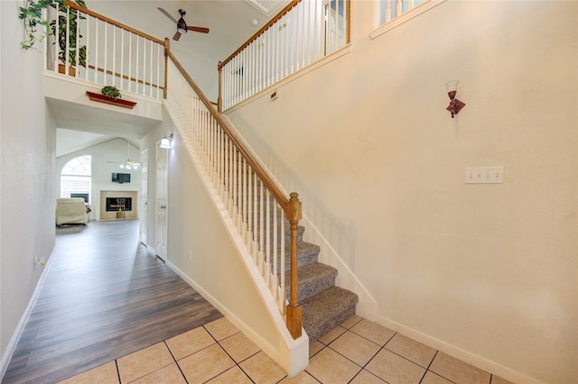 stairway featuring hardwood / wood-style floors and a towering ceiling