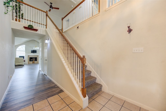 stairs featuring a towering ceiling and hardwood / wood-style flooring