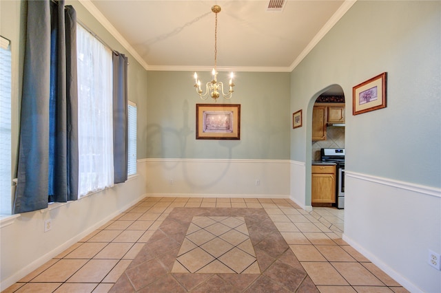 unfurnished dining area featuring a notable chandelier, a healthy amount of sunlight, light tile patterned flooring, and crown molding