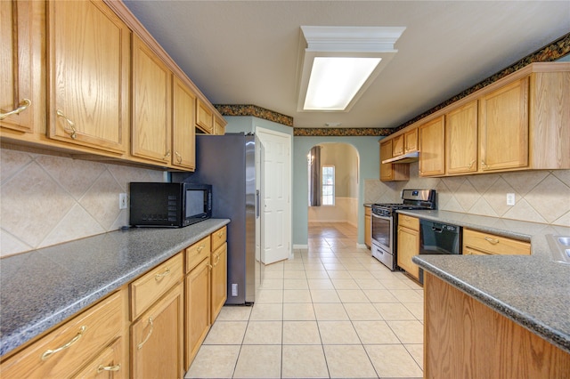 kitchen featuring tasteful backsplash, light tile patterned floors, and black appliances