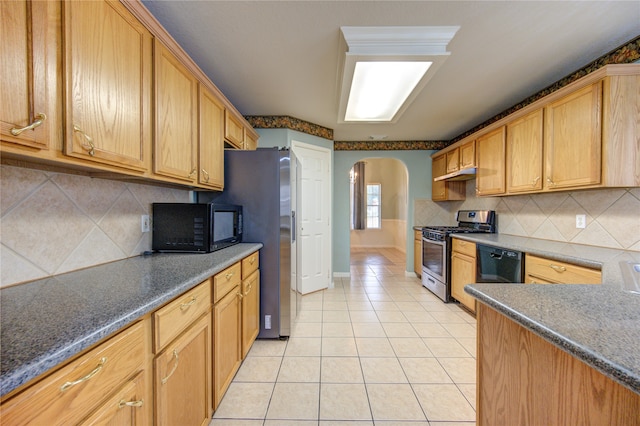 kitchen featuring black appliances, decorative backsplash, and light tile patterned floors