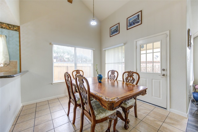 tiled dining room with high vaulted ceiling