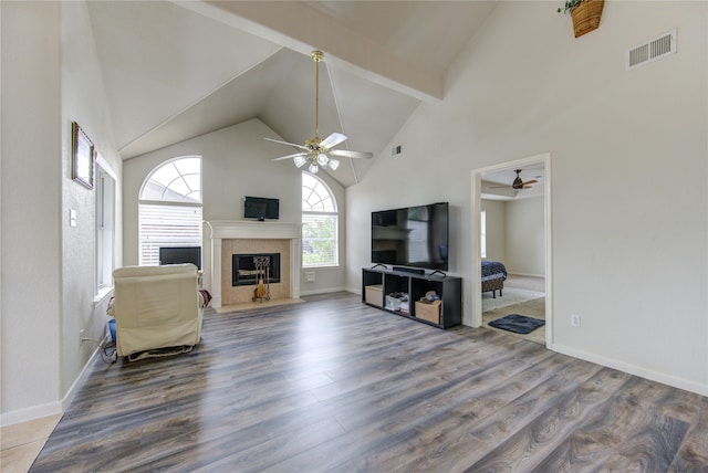 living room with hardwood / wood-style floors, ceiling fan, beamed ceiling, and high vaulted ceiling