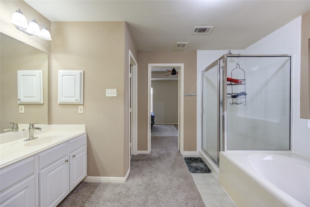 bathroom featuring vanity, tile patterned floors, a textured ceiling, and separate shower and tub