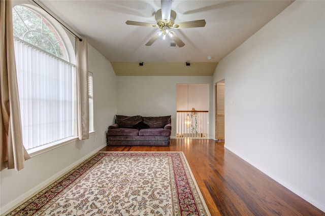 living area with ceiling fan, lofted ceiling, and hardwood / wood-style flooring