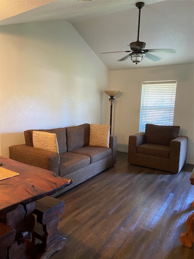 living room with ceiling fan, dark wood-type flooring, and vaulted ceiling