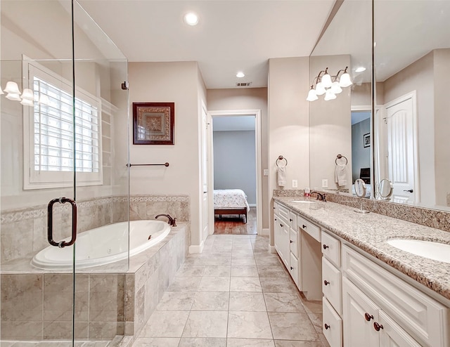 bathroom featuring vanity and a relaxing tiled tub