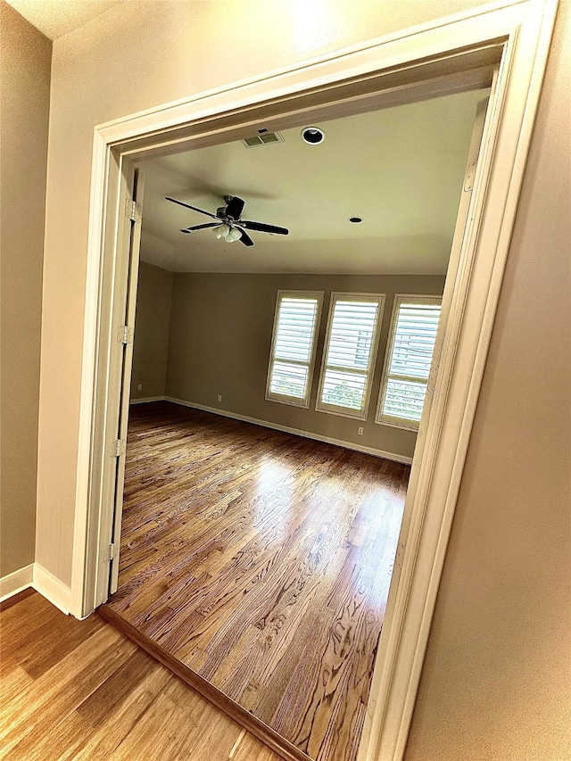 unfurnished room featuring hardwood / wood-style flooring and ceiling fan