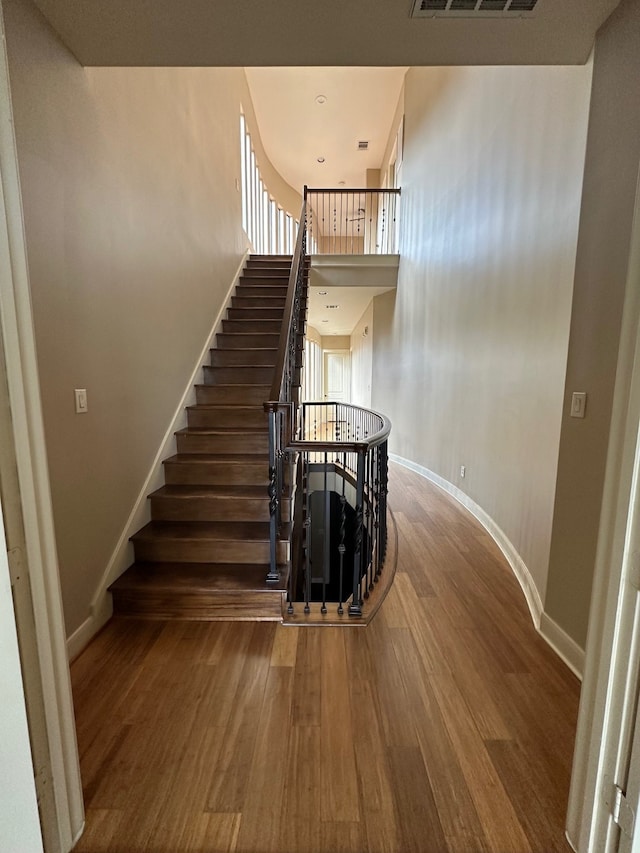 stairway with hardwood / wood-style floors