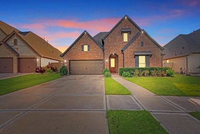 view of front of house featuring a yard and a garage