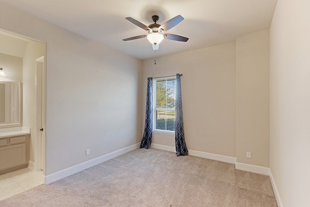 unfurnished room with ceiling fan and light carpet