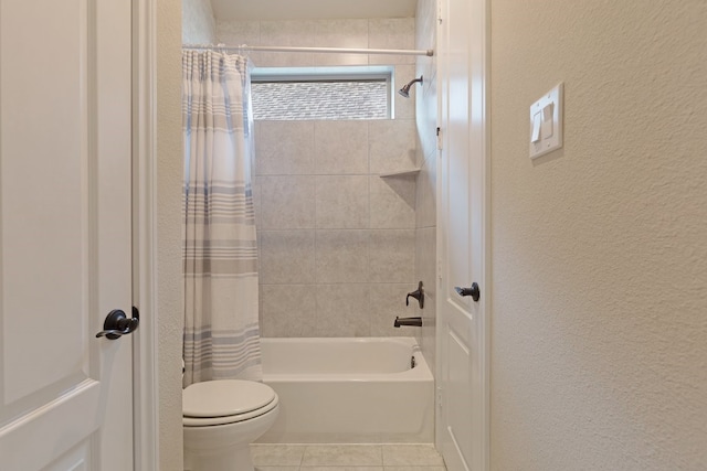 bathroom featuring tile patterned flooring, shower / tub combo, and toilet