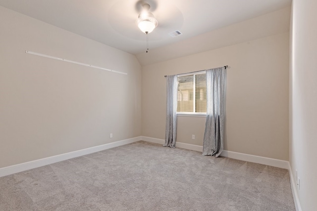 unfurnished room with ceiling fan, light colored carpet, and lofted ceiling