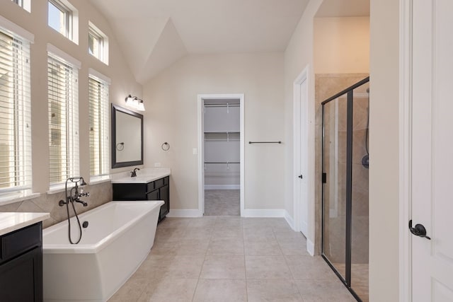 bathroom featuring tile patterned flooring, vanity, independent shower and bath, and lofted ceiling