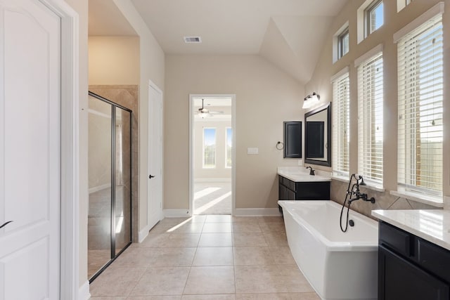 bathroom with tile patterned flooring, shower with separate bathtub, vaulted ceiling, and a wealth of natural light