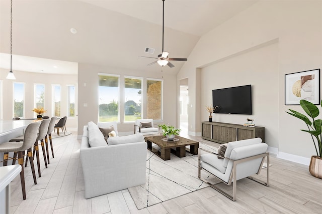 living room featuring ceiling fan, light wood-type flooring, and high vaulted ceiling