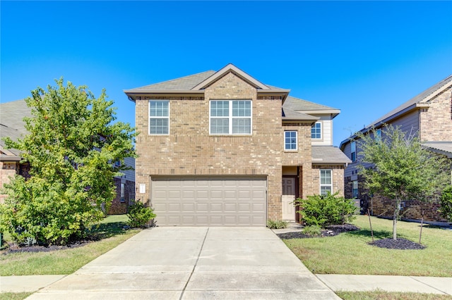 view of front of home featuring a garage and a front lawn