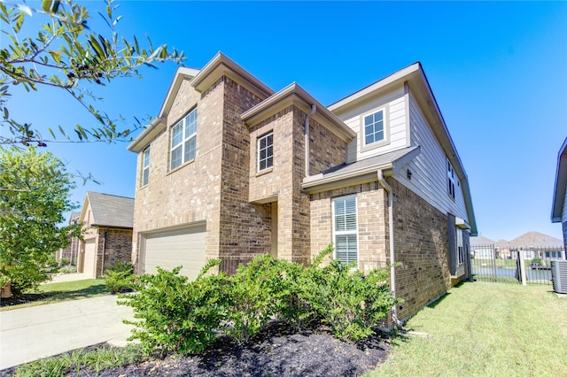 view of front of property featuring a front lawn and a garage