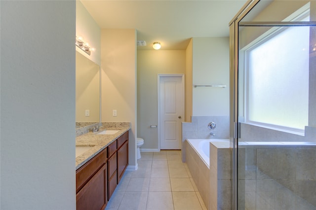 full bathroom with tile patterned floors, separate shower and tub, vanity, and toilet