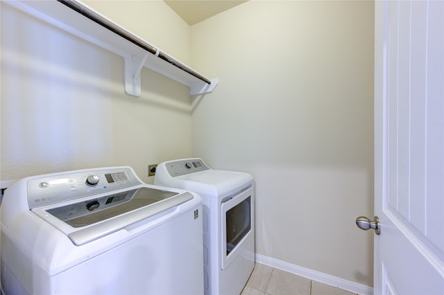 washroom with light tile patterned flooring and separate washer and dryer