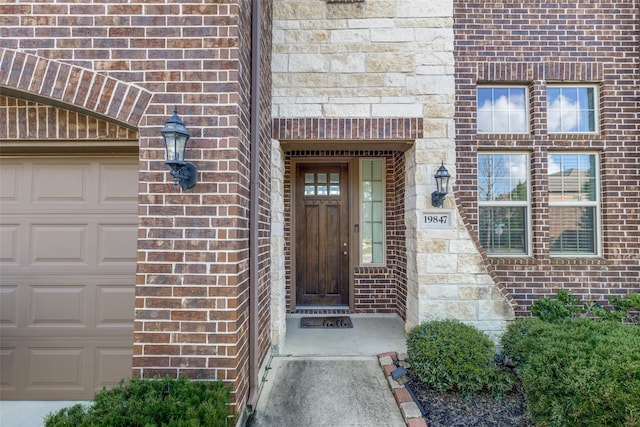 view of exterior entry with a garage