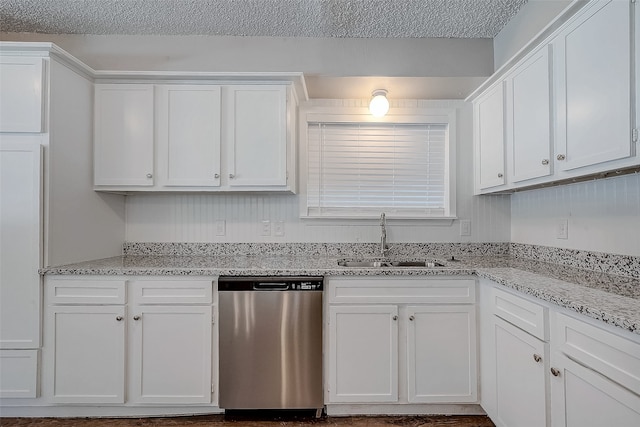 kitchen featuring light stone countertops, white cabinets, a textured ceiling, sink, and dishwasher