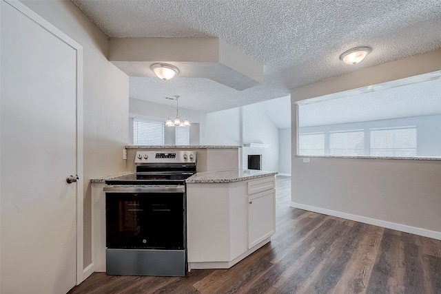 kitchen featuring electric range, dark hardwood / wood-style flooring, pendant lighting, a textured ceiling, and white cabinets