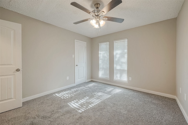 carpeted empty room featuring a textured ceiling and ceiling fan