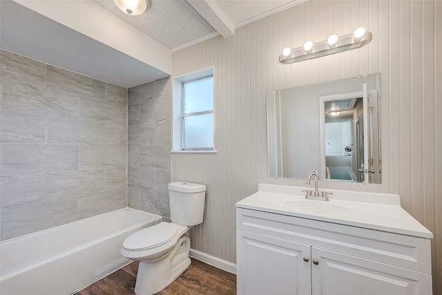 full bathroom featuring vanity, wood-type flooring, toilet, tiled shower / bath, and wood walls