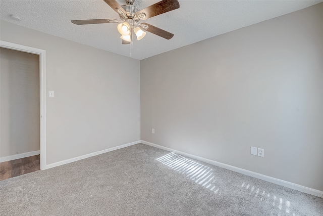 empty room with carpet, ceiling fan, and a textured ceiling