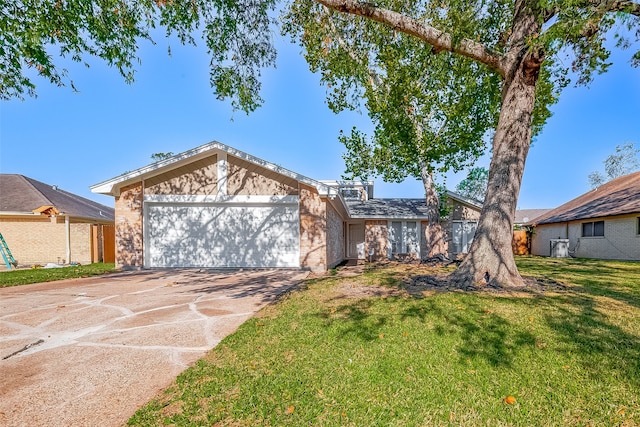 single story home featuring a front lawn and a garage