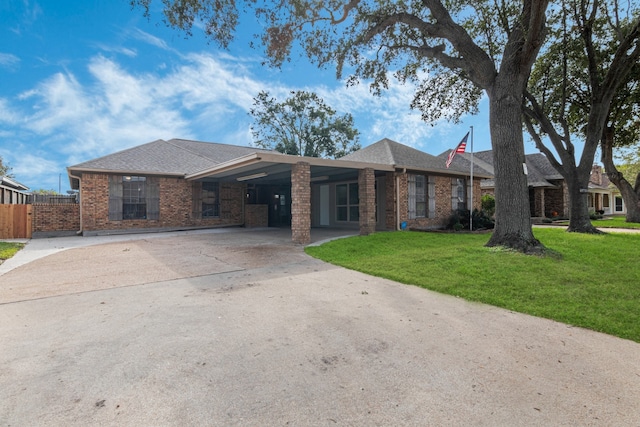 single story home with a front lawn and a carport