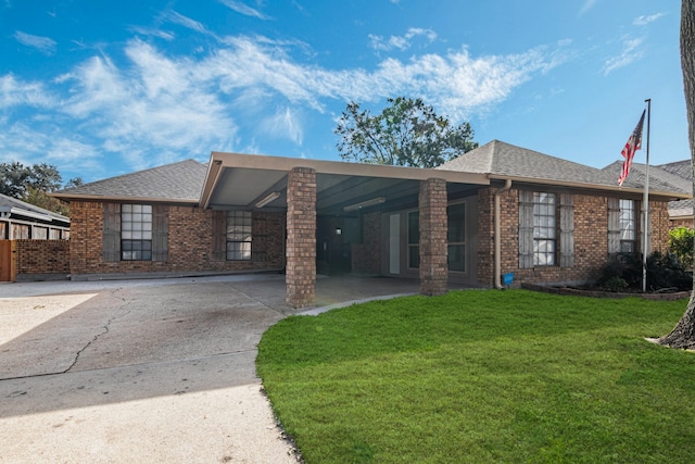 view of front of property with a front lawn and a carport