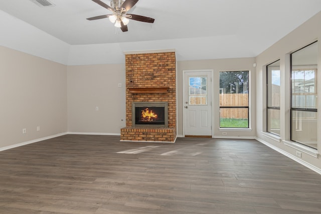 unfurnished living room featuring a fireplace, ceiling fan, and dark wood-type flooring