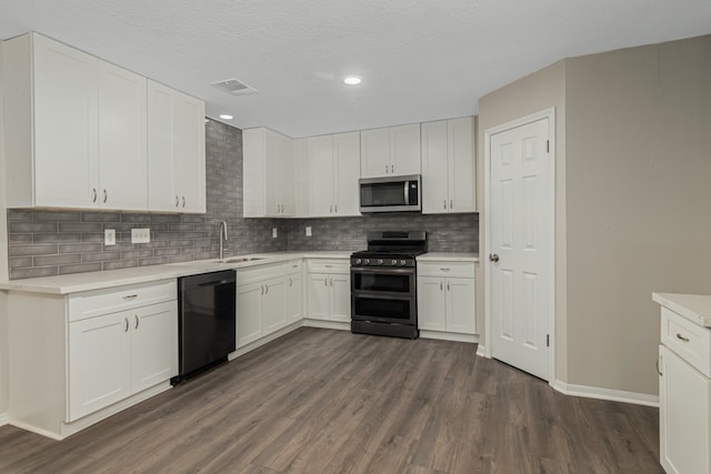 kitchen featuring sink, white cabinets, stainless steel appliances, and dark hardwood / wood-style floors