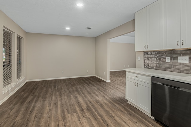 kitchen featuring stainless steel dishwasher, dark hardwood / wood-style floors, light stone counters, and white cabinetry