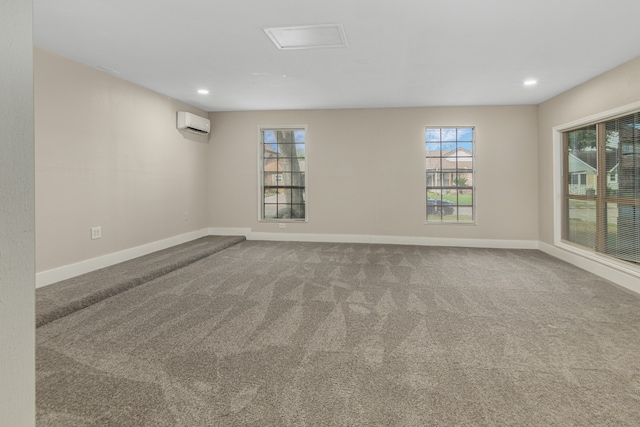 carpeted spare room featuring a wall mounted AC