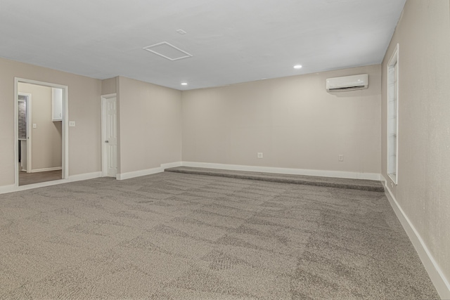 carpeted spare room featuring a wall unit AC