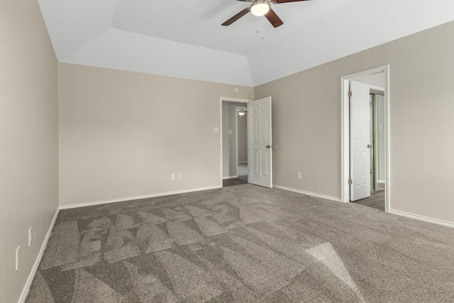 carpeted empty room with ceiling fan and vaulted ceiling