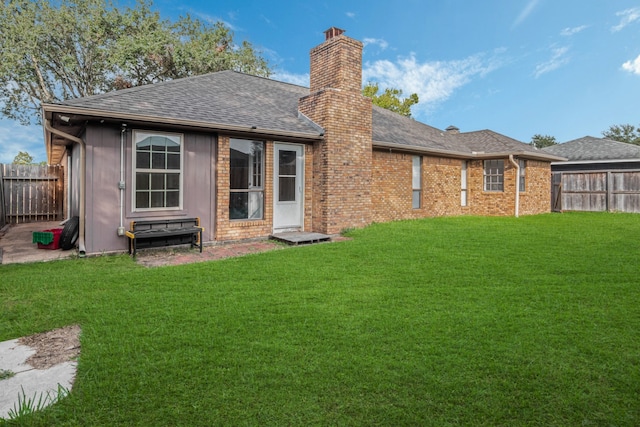 back of house featuring a lawn