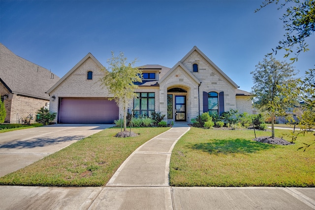 view of front of home with a garage and a front yard