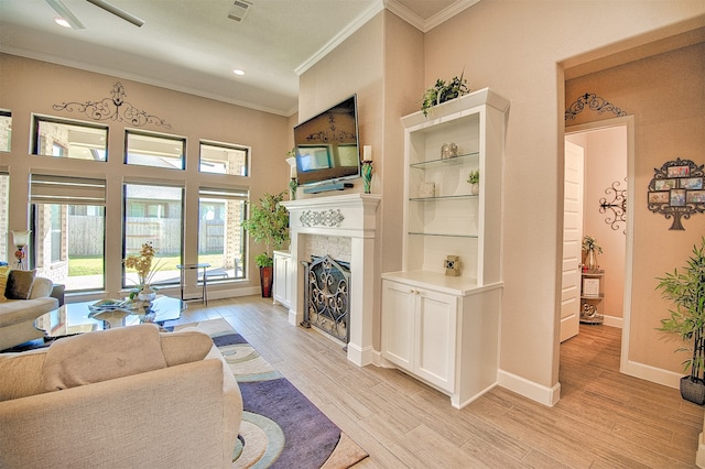 living room with light hardwood / wood-style floors and crown molding