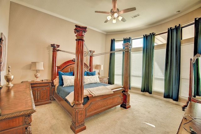 carpeted bedroom featuring ceiling fan and crown molding